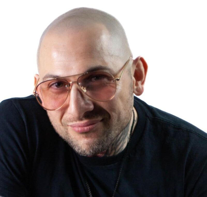 Nader Eid, seated, looking at viewer, founder and host of Threshold, guiding storytellers to own their voice